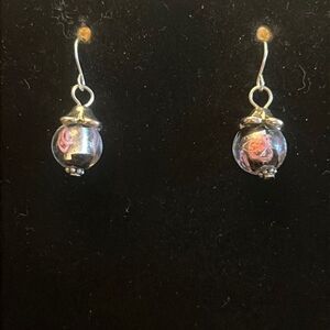 Handcrafted silver tone earrings with glass bead.